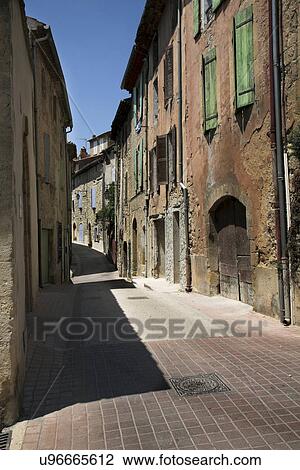Narrow brick street through old city View Large Photo Image Stock Image - Narrow brick street through old city. Fotosearch