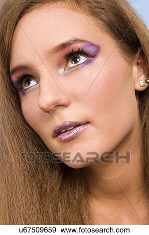 Purple eye make-up on young woman View Large Photo Image Stock Photo - Purple eye make-up on young woman. Fotosearch