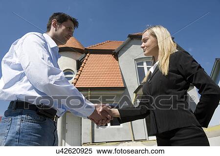 Realtor shaking hands with customer View Large Photo Image Stock Photography - Realtor shaking hands with customer. Fotosearch