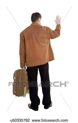 Rear view of man carrying suitcase View Large Photo Image Stock Image - Rear view of man carrying suitcase. Fotosearch