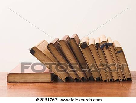 Stock Image - Row of hard covered books. Fotosearch