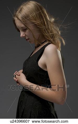 Stock Photo - Side view of model in black dress. Fotosearch