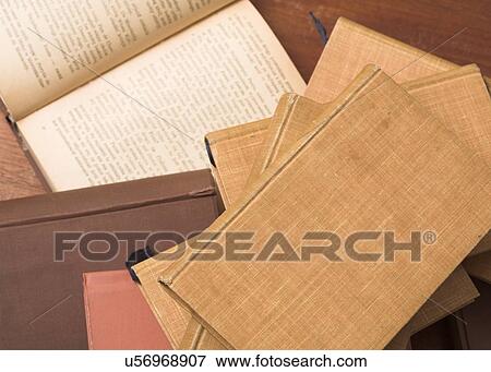 Stock Photo - Stack of books with one open. Fotosearch
