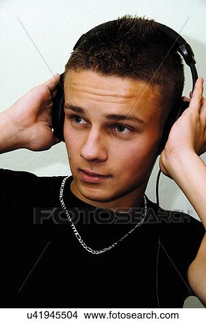 Teenager listening to music through headphones View Large Photo Image Picture - Teenager listening to music through headphones. Fotosearch