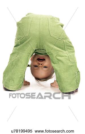 Stock Photography - Toddler playing peekaboo. Fotosearch