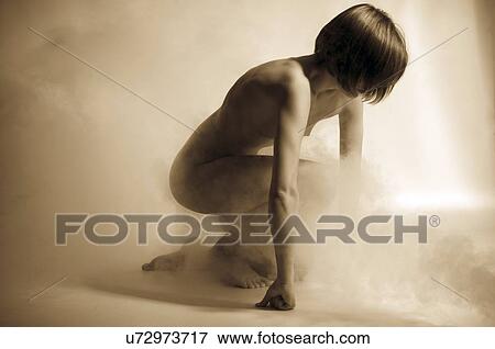 Stock Photo - Topless woman crouching. Fotosearch