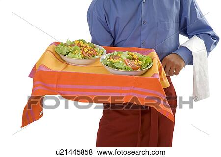 Stock Photo - Waiter serving salad. Fotosearch