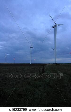 Wind turbines under cloudy sky View Large Photo Image Stock Photo - Wind turbines under cloudy sky. Fotosearch