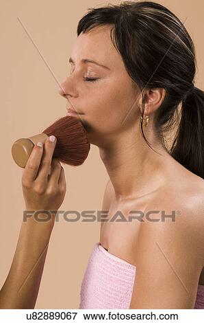 Woman applying make-up View Large Photo Image Stock Photo - Woman applying make-up. Fotosearch