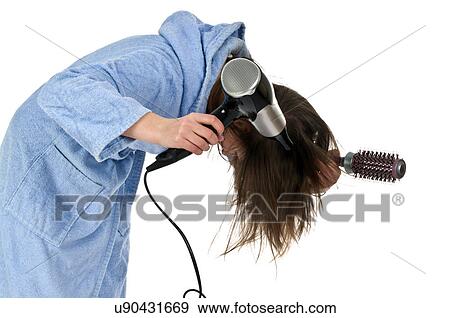 Woman blow drying her hair View Large Photo Image Stock Photo - Woman blow drying her hair. Fotosearch