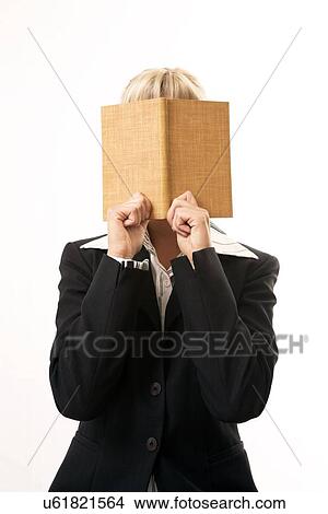 Picture - Woman hiding behind a book. Fotosearch