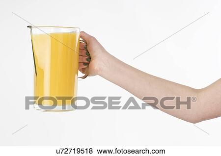 Woman holding a pitcher of orange juice View Large Photo Image Stock Photo - Woman holding a pitcher of orange juice. Fotosearch