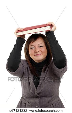 Woman holding book over head View Large Photo Image Stock Image - Woman holding book over head. Fotosearch