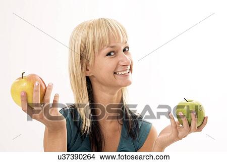 Woman holding two apples View Large Photo Image Picture - Woman holding two apples. Fotosearch