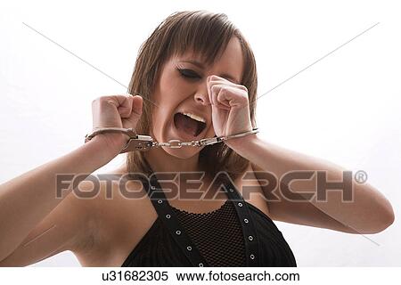 Stock Photography - Woman in handcuffs. Fotosearch