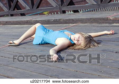 Picture - Woman laying in the sun. Fotosearch