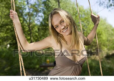 Woman on tree swing View Large Photo Image Stock Photo - Woman on tree swing. Fotosearch