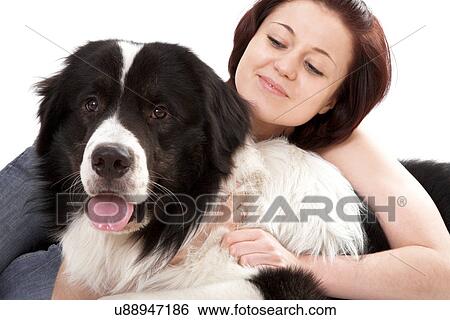 Stock Photograph - Woman petting sheepdog. Fotosearch
