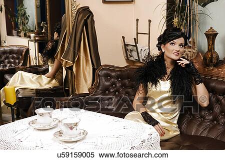 Woman sitting in dining room View Large Photo Image Stock Photography - Woman sitting in dining room. Fotosearch