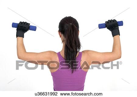 Stock Image - Woman using hand weights. Fotosearch
