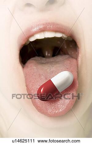 Women sticking tongue out with pill on it View Large Photo Image Stock Image - Women sticking tongue out with pill on it. Fotosearch