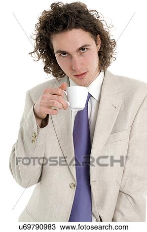 Stock Image - Young business man holding coffee cup. Fotosearch