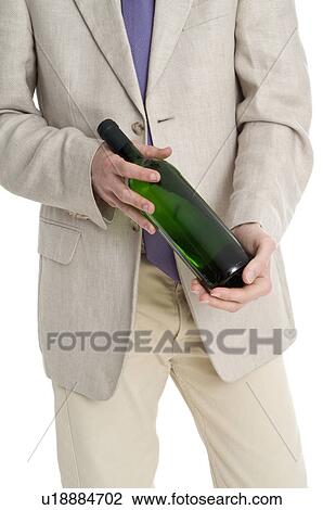 Young man dressed up and holding a wine bottle View Large Photo Image Stock Image - Young man dressed up and holding a wine bottle. Fotosearch
