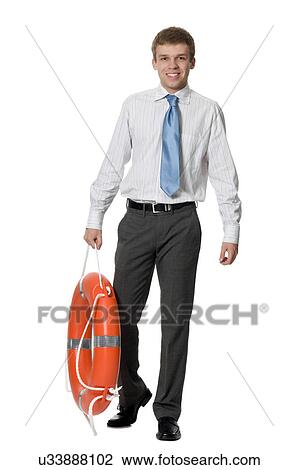 Young man holding life ring View Large Photo Image Stock Image - Young man holding life ring. Fotosearch