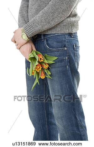 Young man holding tulips View Large Photo Image Stock Photo - Young man holding tulips. Fotosearch