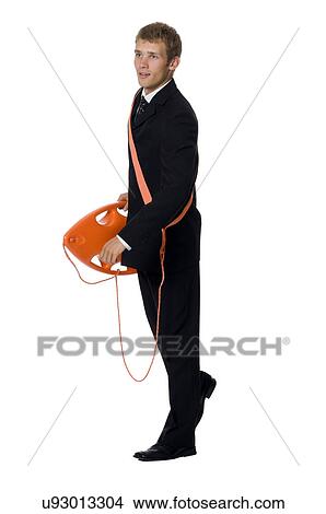 Picture - Young man in business suit holding flotation device. Fotosearch