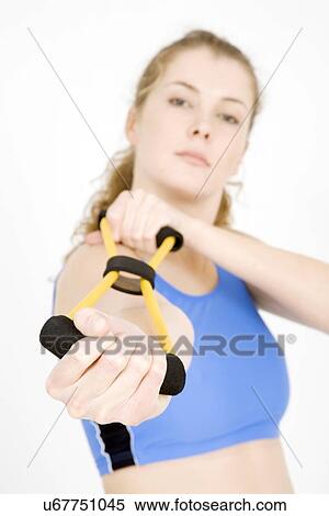 Young woman exercising her arm View Large Photo Image Stock Photography - Young woman exercising her arm. Fotosearch