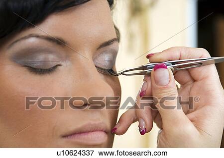Young woman getting eyelashes done View Large Photo Image Stock Photo - Young woman getting eyelashes done. Fotosearch