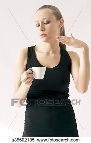 Young woman holding coffee cup View Large Photo Image Stock Photography - Young woman holding coffee cup. Fotosearch