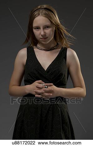 Stock Image - Young woman in black dress. Fotosearch