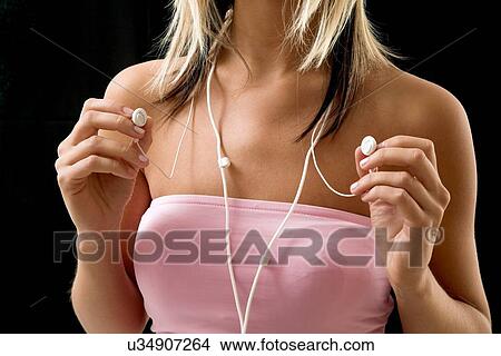 Young woman with earbuds View Large Photo Image Picture - Young woman with earbuds. Fotosearch