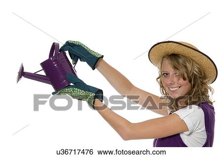 Stock Photograph - Young woman with gardening supplies. Fotosearch