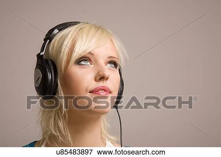 Young woman with headphones on View Large Photo Image Stock Photo - Young woman with headphones on. Fotosearch
