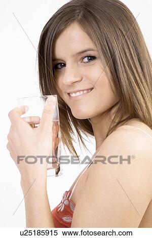 Young women holding a glass View Large Photo Image Stock Photography - Young women holding a glass. Fotosearch