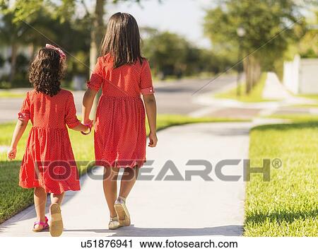 Back view of girls( 4-5, 8-9) holding hands View Large Photo Image Stock Image - Back view of girls( 4-5, 8-9) holding hands. Fotosearch