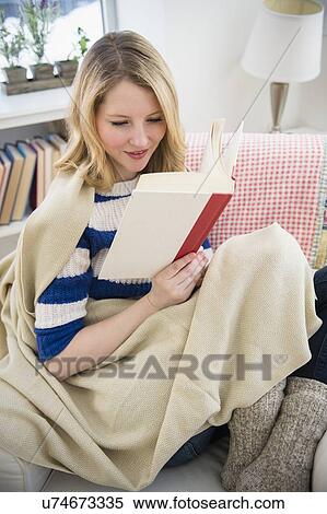Blond woman reading on sofa View Large Photo Image Stock Photography - Blond woman reading on sofa. Fotosearch