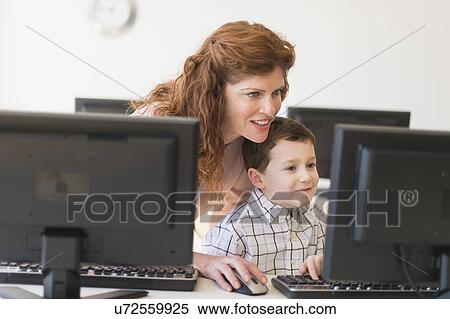 boy (6-7) and teacher using computer View Large Photo Image Stock Photography - boy (6-7) and teacher using computer. Fotosearch
