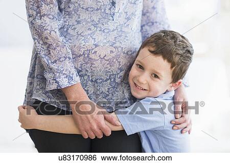 boy (6-7) embracing mother View Large Photo Image Stock Photograph - boy (6-7) embracing mother. Fotosearch