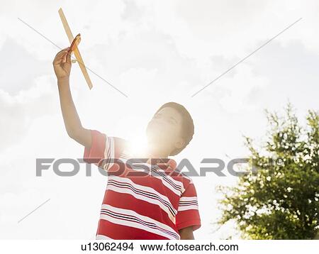 boy (6-7) playing with toy airplane View Large Photo Image Picture - boy (6-7) playing with toy airplane. Fotosearch