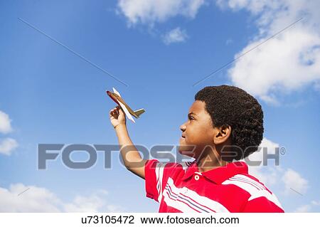 boy (6-7) playing with toy airplane View Large Photo Image Stock Image - boy (6-7) playing with toy airplane. Fotosearch