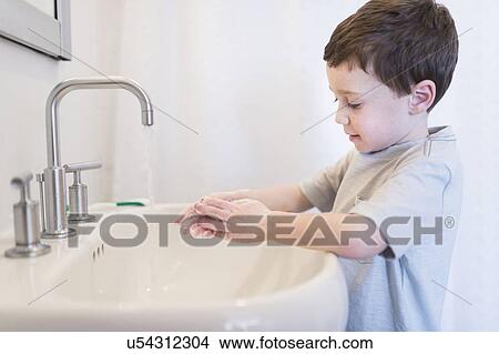 boy (6-7) washing hands View Large Photo Image Picture - boy (6-7) washing hands. Fotosearch