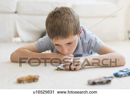 boy (8-9) playing with toy cars View Large Photo Image Stock Image - boy (8-9) playing with toy cars. Fotosearch