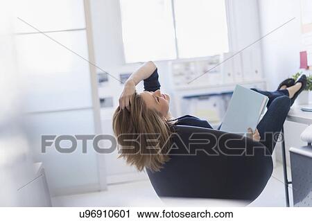 Business woman relaxing in office View Large Photo Image Stock Image - Business woman relaxing in office. Fotosearch