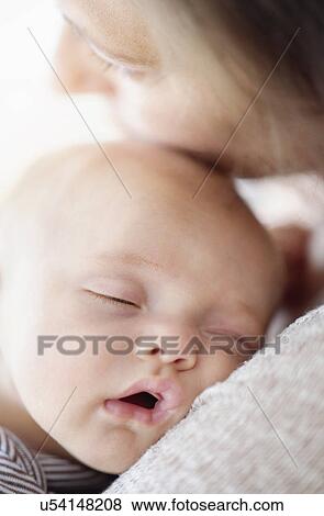 Close up of baby boy (2-5 months) sleeping on mother's shoulder View Large Photo Image Stock Photo - Close up of baby boy (2-5 months) sleeping on mother's shoulder. Fotosearch