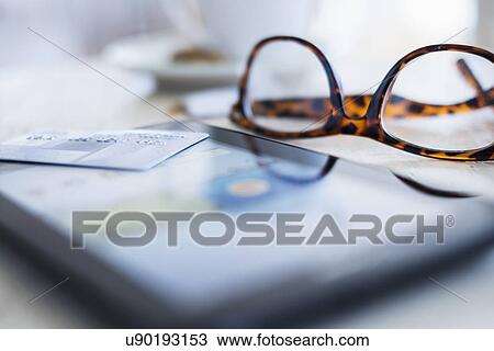 Close up of glasses and smartphone on table View Large Photo Image Stock Image - Close up of glasses and smartphone on table. Fotosearch