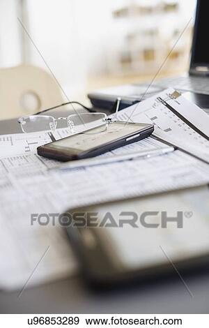 Close up of glasses on paperwork View Large Photo Image Stock Photo - Close up of glasses on paperwork. Fotosearch